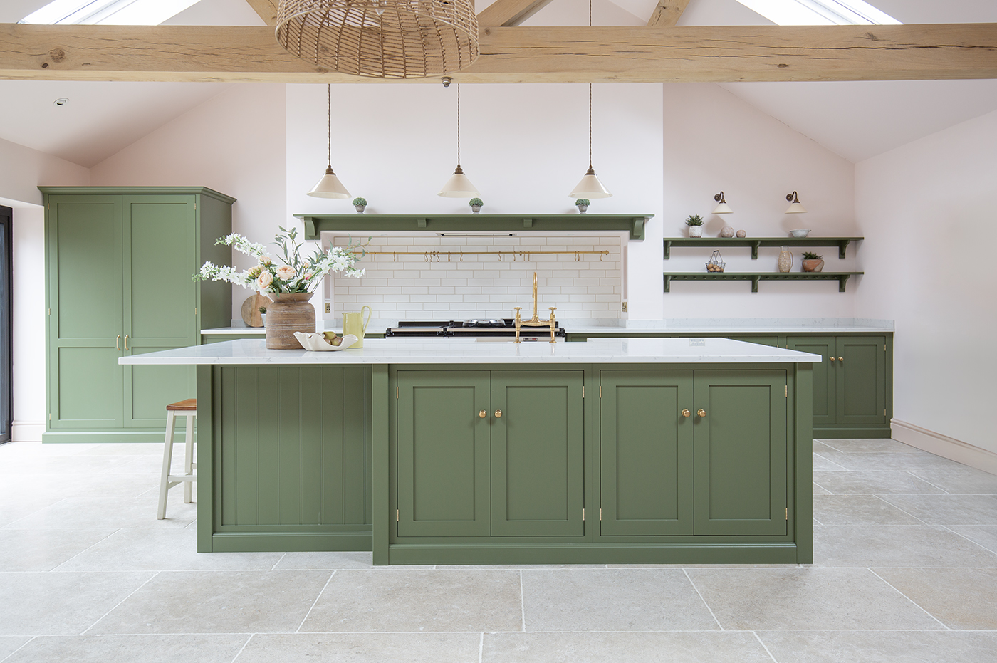 Dijon Tumbled Limestone flooring with green island with wooden beam